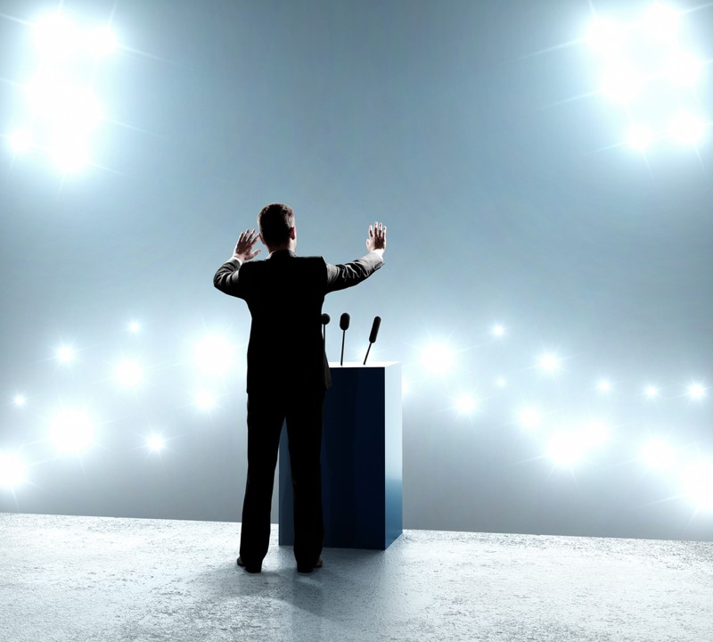 Businessman standing on podium and closes on outbreaks